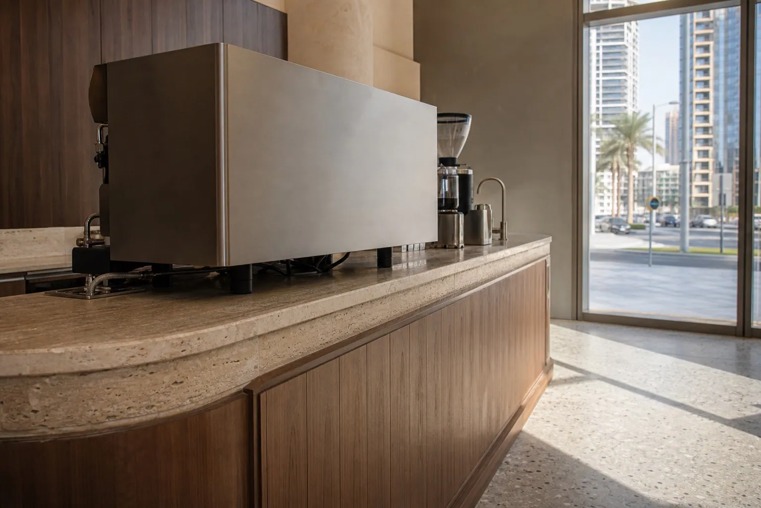 Specialty coffee shop fit-out in Dubai with espresso bar counter and seating in warm daylight