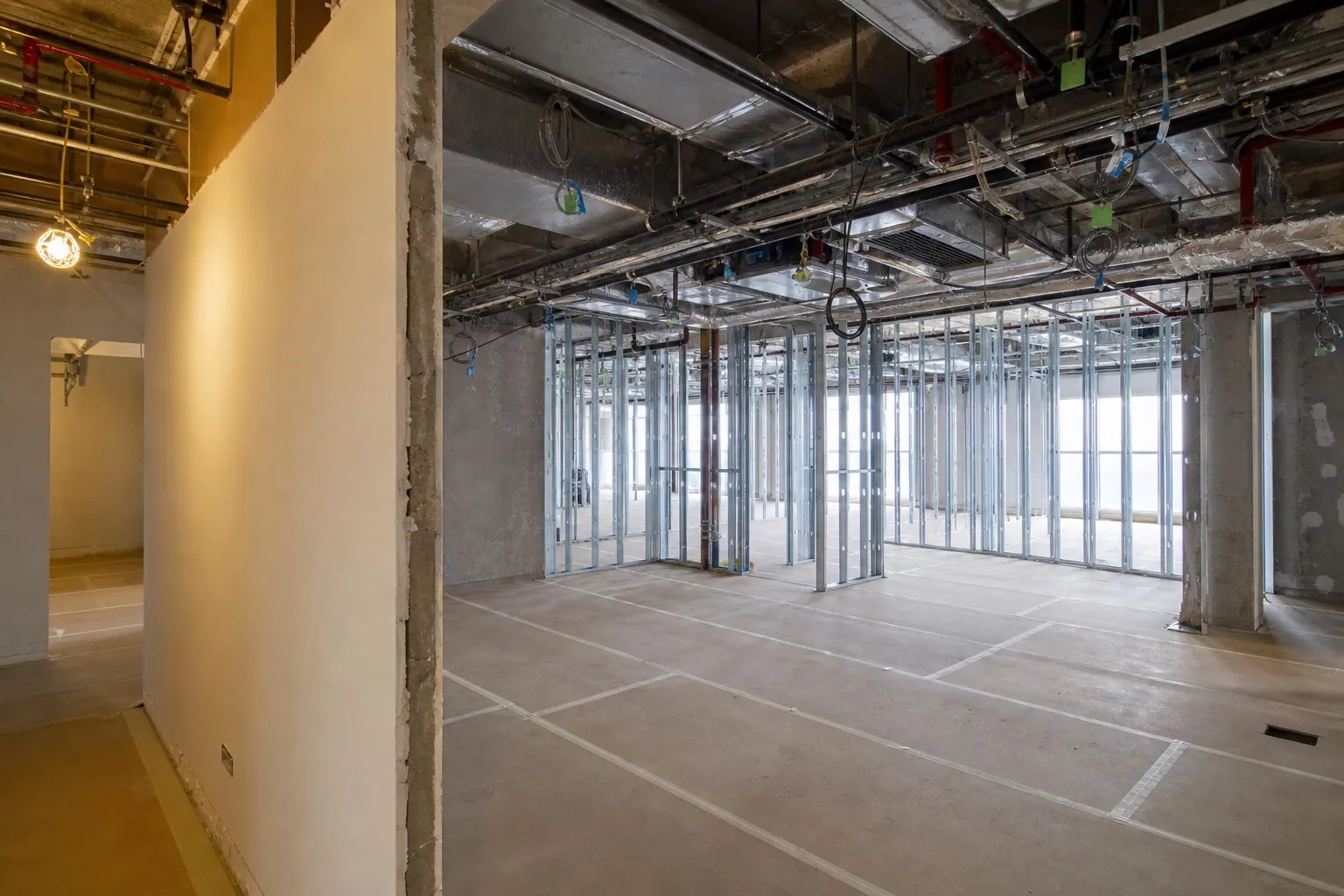 Renovation works in progress in a Dubai commercial unit with protected flooring and new partitions